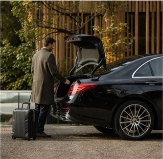 Driver helping with airport luggage